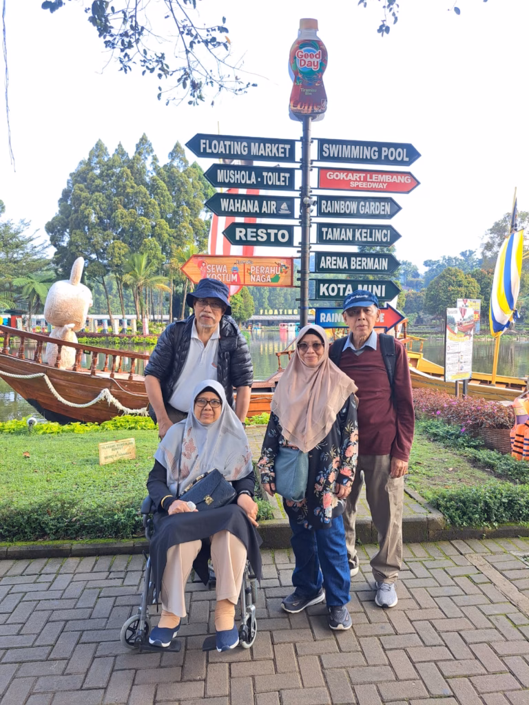 Family with elderly member in wheelchair visiting Floating Market Lembang, guided by Bandung Driver.