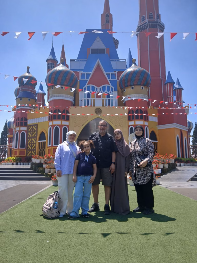 Family posing in front of the colorful fairytale castle at D’Castello Lembang Bandung