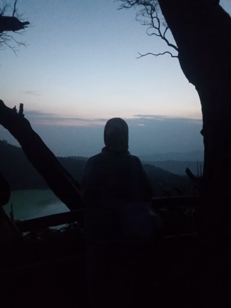 Tourist silhouette watching sunrise at Sunan Ibu viewpoint near Kawah Putih Ciwidey Bandung